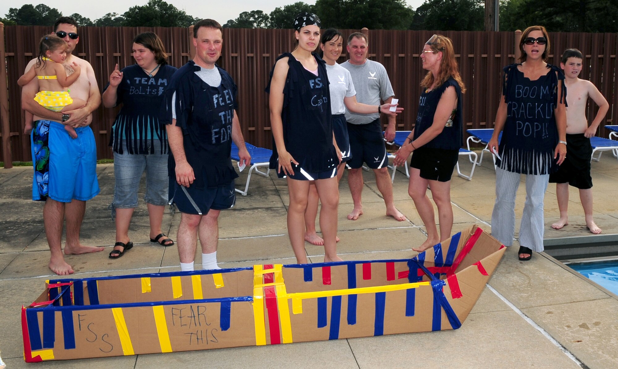 Team Bolt, 4th Force Support Squadron, participates in pre-competition "smacktalk" before beginning their race during the build-a-boat competition at Seymour Johnson Air Force Base, N.C., June 10, 2009.  Shortly after the launch of their vessel, it sank. (U.S. Air Force photo by Airman 1st Class Rae Perry)
