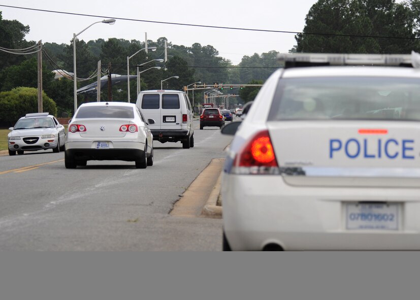 Patrolmen from the 4th Security Forces Squadron ensure compliance with base traffic laws by monitoring drivers along Wright Brothers Avenue on Seymour Johnson Air Force Base, N.C., June 4, 2009. Whether a traffic violation is committed in the local community or on the installation, base driving privileges for Airmen can be revoked. Since January 2009, 16 Airmen have lost base driving privileges due to off-base violations. (U.S. Air Force photo by Senior Airman Makenzie Lang)