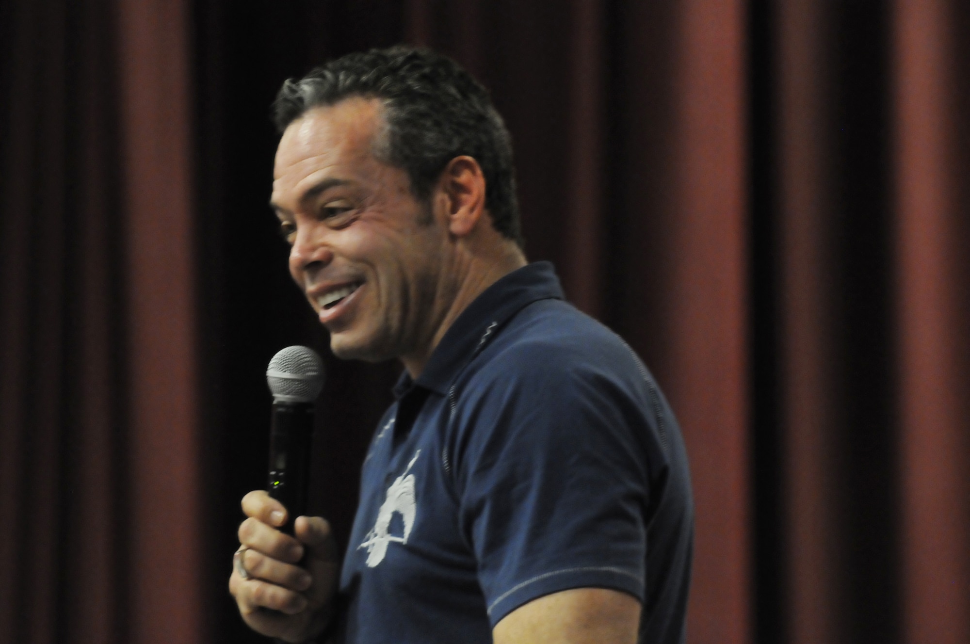Comedian Bernie McGrenahan performs during a Happy Hour Comedy Tour performance at the Robins Theater June 9. The show combines humor with an inspirational message. U. S. Air Force photo by Sue Sapp