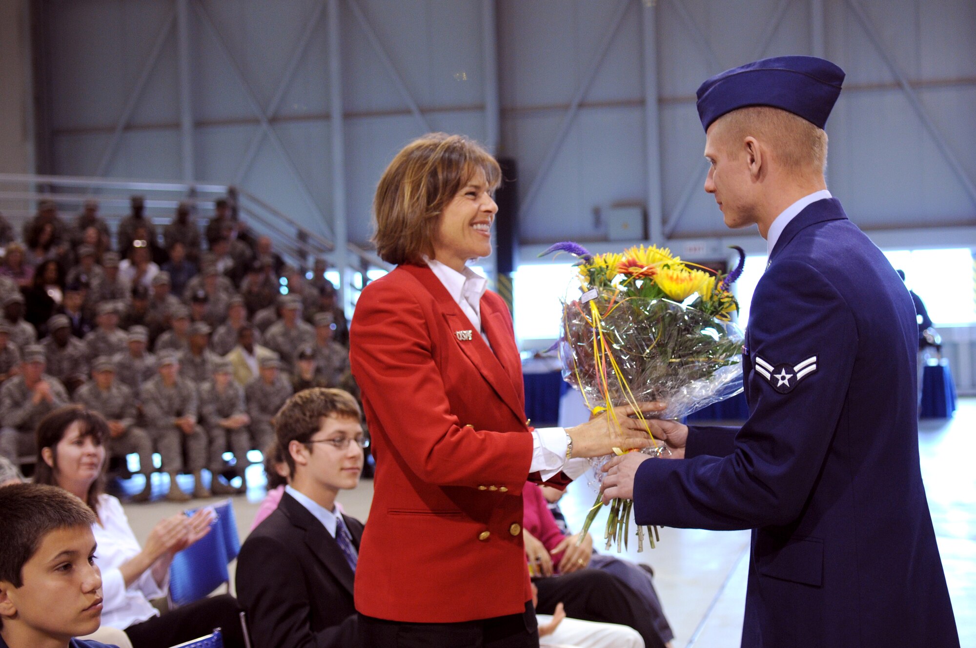 435th Air Base Wing commander’s wife, Stephania Gould, receives flower at the change of command ceremony in Hangar one, Ramstein Air Base, Germany, June 11, 2009.  (U.S. Air Force photo by Staff Sgt. Levi Riendeau)