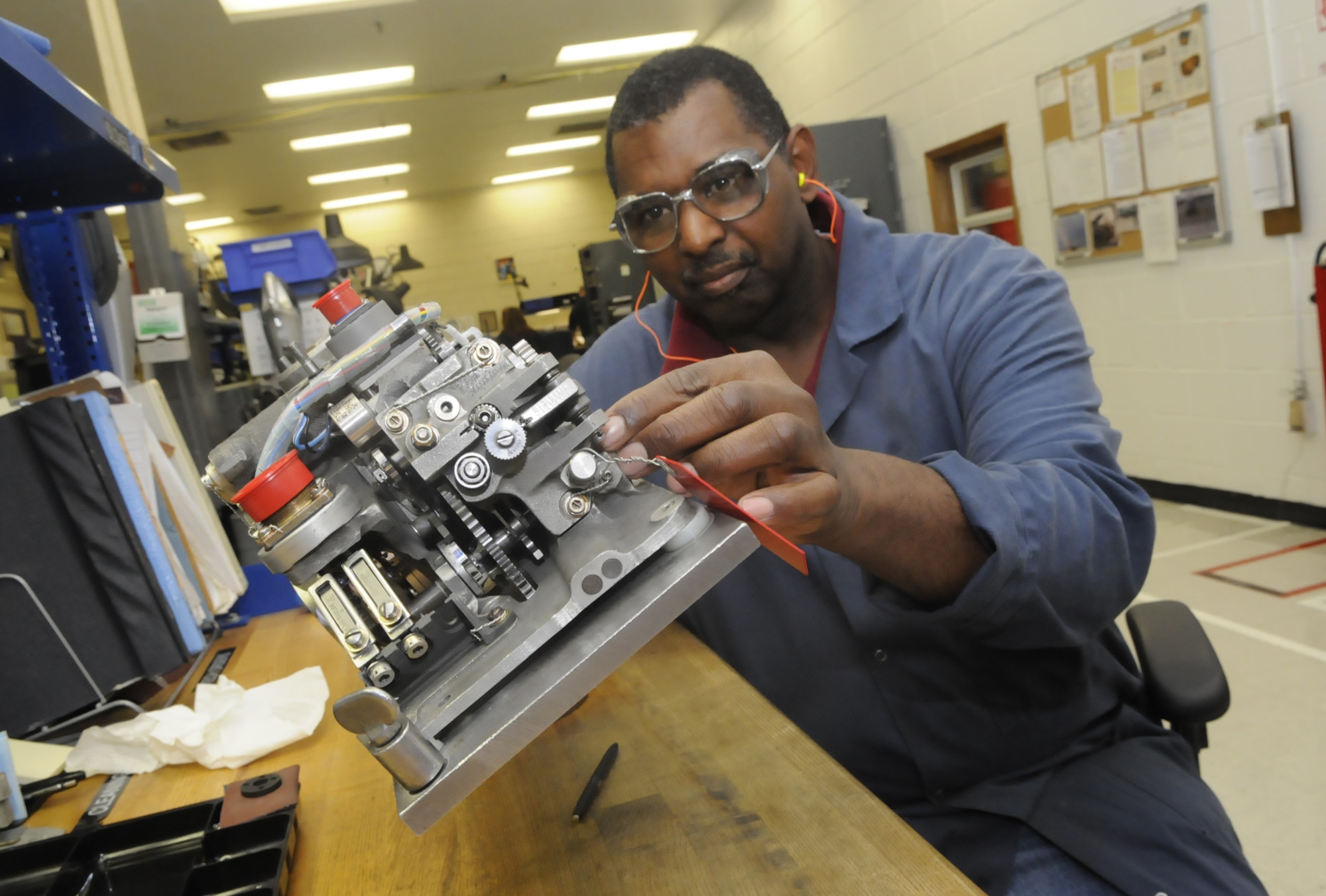 Garry McCrary, propeller mechanic, overhauls a C-130 valve housing. which turns the angles on the blades when a propeller is running. U. S. Air Force photo by Sue Sapp