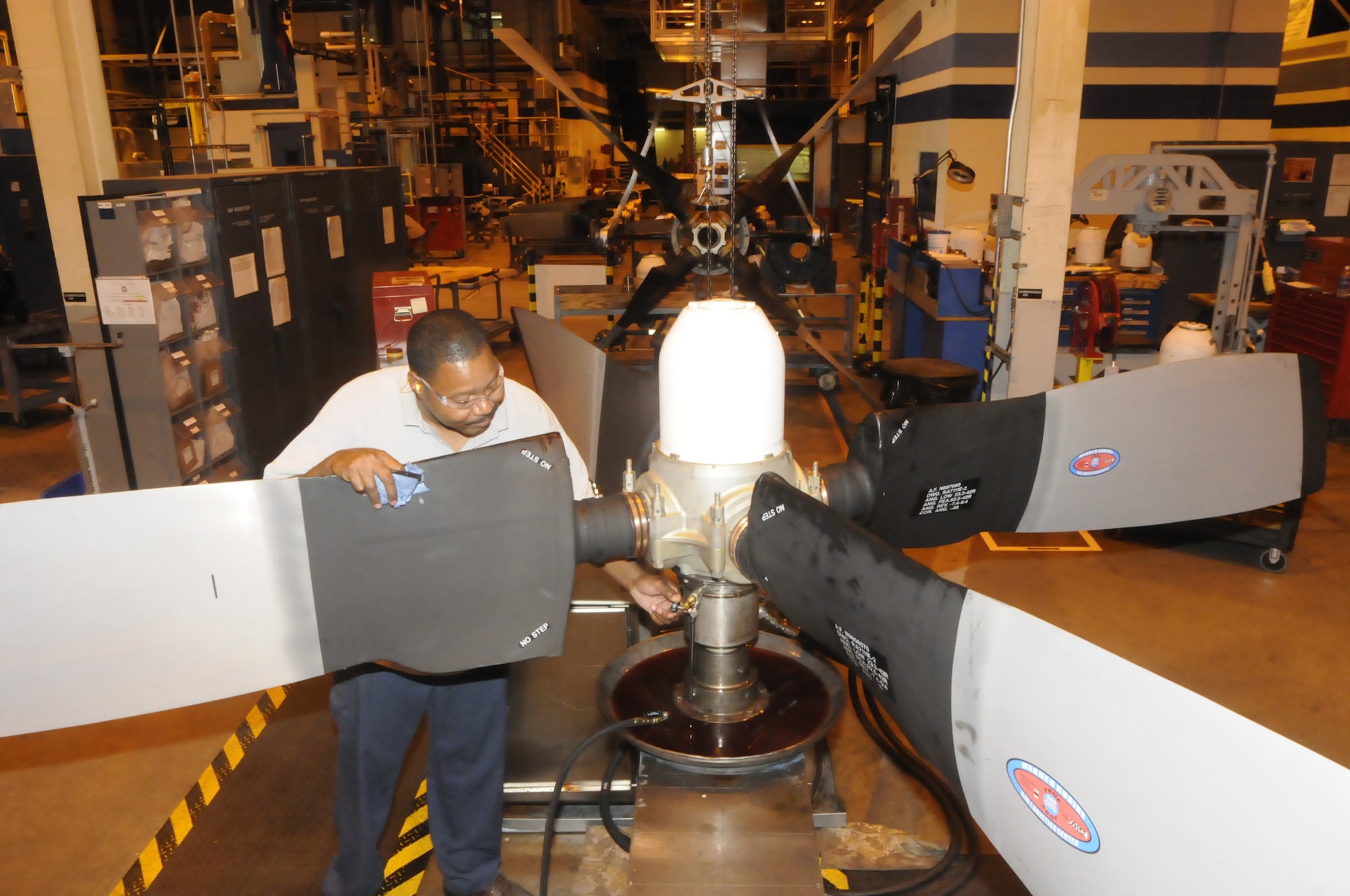 Darrell Carter, propeller mechanic, performs final assembly testing or a C-130 propeller. U. S. Air Force photo by Sue Sapp