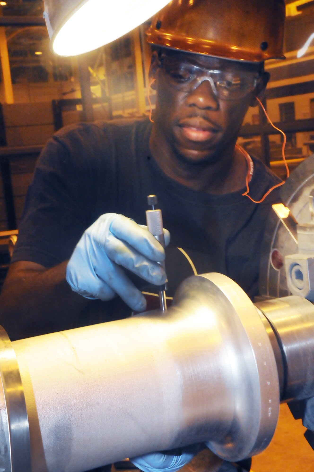 Brian Bradley, machinist, measures the outside diameter of a propeller blade so it can be cut down to size. U. S. Air Force photo by Sue Sapp