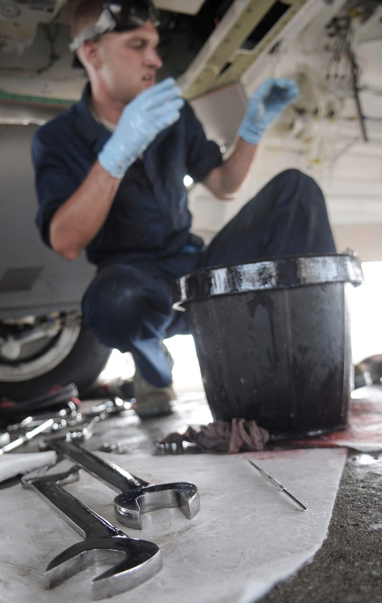 Staff Sgt. Jeremiah Smith, 525th Expeditionary Aircraft Maintenance Unit F-22 crew chief, works on the hydraulic pump of an F-22 Raptor June 3. (U.S. Air Force photo/Senior Airman Christopher Bush)