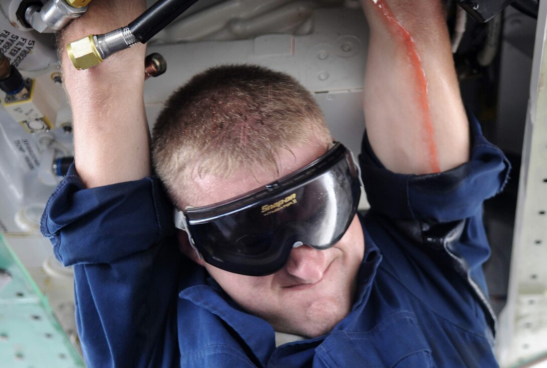 Senior Airman Theodore Cupp, an F-22 crew chief assigned to 525th Expeditionary Aircraft Maintenance Unit, performs maintenance on a hydraulic pump of an F-22 June 3. The Mendon, Mich., native, is deployed to Andersen Air Force Base, Guam from Elmendorf Air Force Base, Alaska in support of U.S. Pacific Command's Theatre Security Package. (U.S. Air Force photo/Senior Airman Christopher Bush)