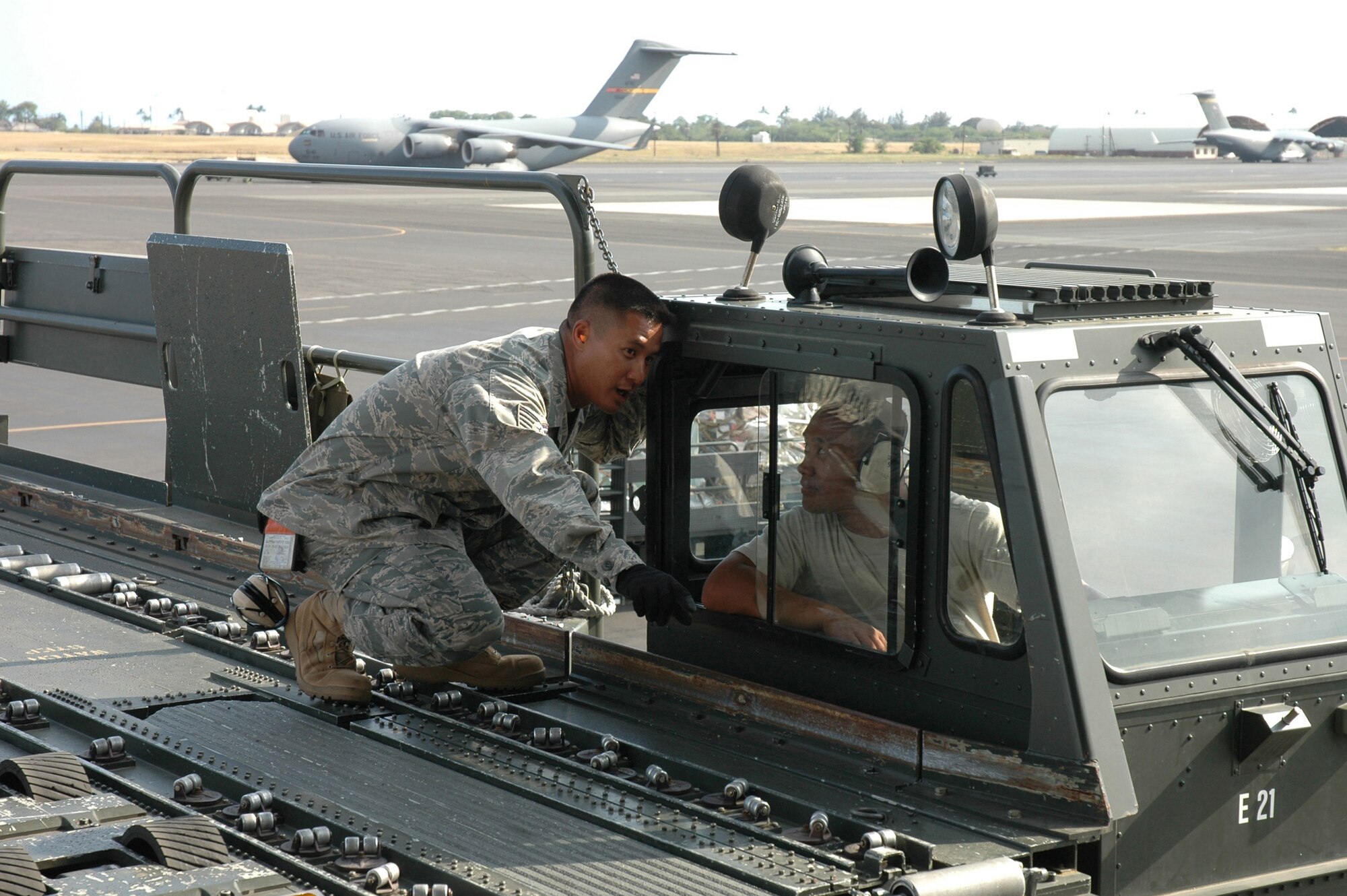 Tech. Sgt. Daniel Elvenia, left, and Senior Airman Derek Dumlao discuss the best approach for loading cargo May 16, 2009, during their May drill weekend at Hickam Air Force Base, Hawaii. They are reservists with the 48th Aerial Port Squadron, which was named the Air Force's best Air Reserve Component Air Transportation Activity for 2008. The squadron is part of the 624th Regional Support Group at Hickam. (U.S. Air Force photo/Capt. Christy Stravolo)