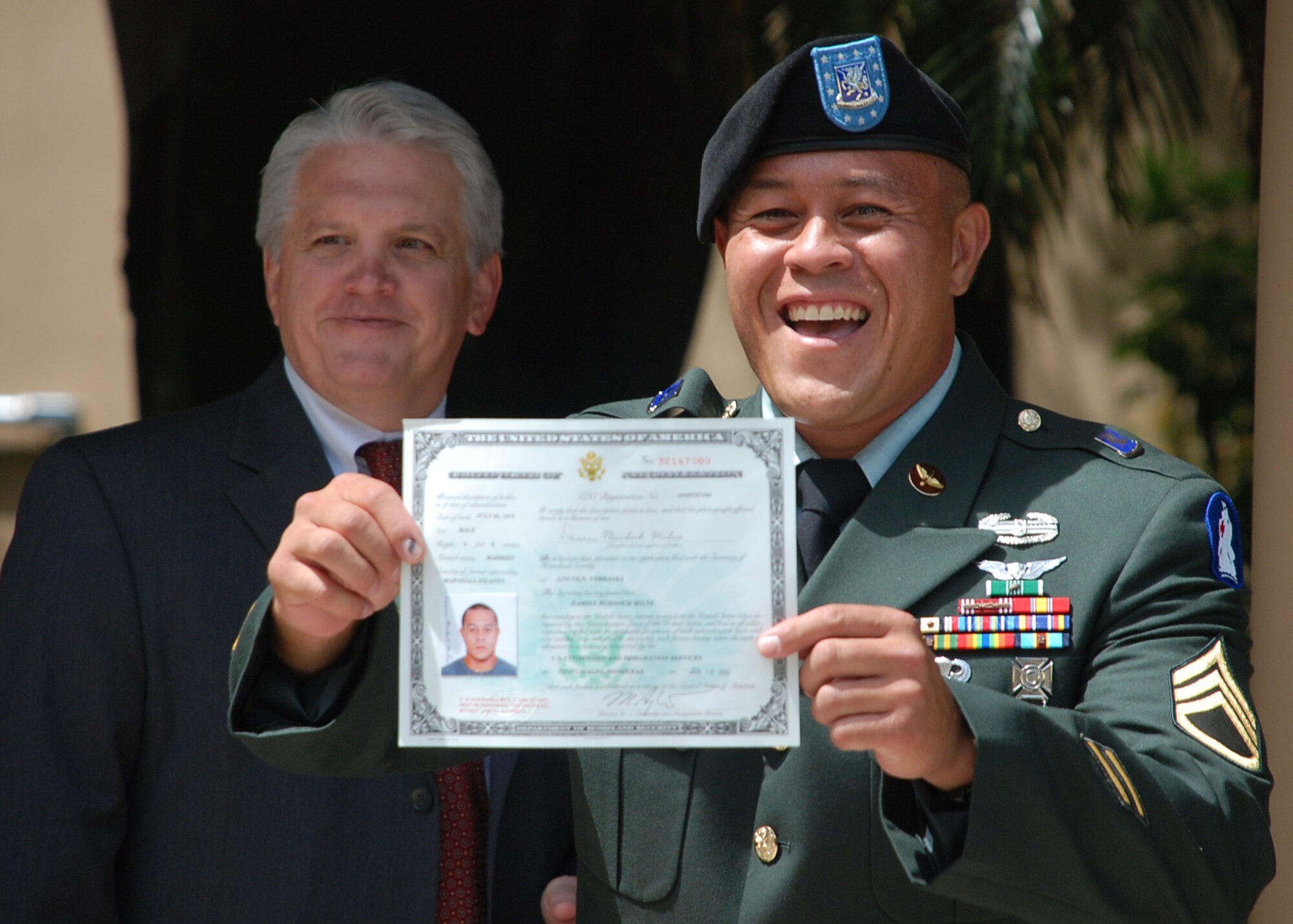 TEGUCIGALPA, Honduras - U.S. Army Staff Sgt. Damien Milne shows off his certificate of U.S. citizenship following his naturalization in a formal ceremony at the U.S. embassy here June 10.  Sergeant Milne is from the Marshall Islands.  He is a two-time Iraq war veteran and is currently assigned to Joint Task Force-Bravo's 1st Battalion, 228th Aviation Regiment.  His ceremony here was the first U.S. naturalization ceremony to take place in Central America.  (U.S. Air Force
photo/Tech. Sgt. Rebecca Danét)
