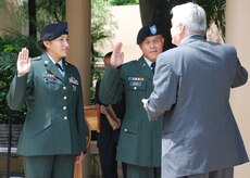 TEGUCIGALPA, Honduras - U.S. Army Sgt. Carmen Villa and U.S. Army Staff Sgt.
Damien Milne take the oath of U.S. citizenship in a formal ceremony at the
U.S. embassy here June 10.  Sergeant Villa comes to the U.S. from Mexico and
Sergeant Milne is from the Marshall Islands.  Both Soldiers are two-time
Iraq war veterans.  The oath was administered by U.S. Citizenship and
Immigration Services acting Deputy Director Michael Aytes.  (U.S. Air Force
photo/Tech. Sgt. Rebecca Danét)
