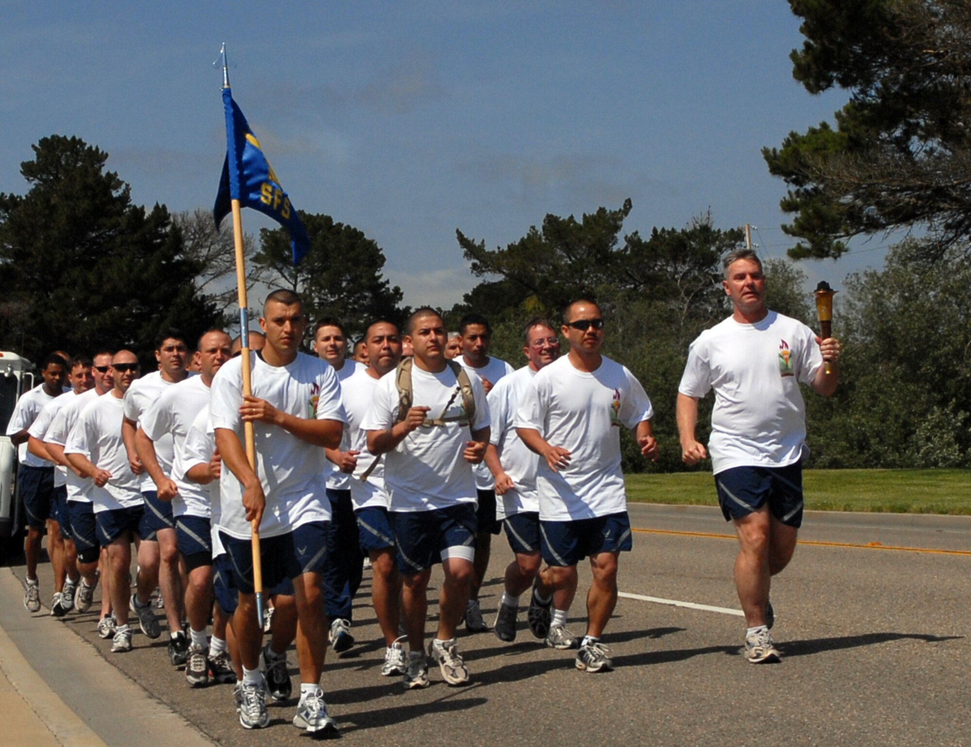 VANDENBERG AIR FORCE BASE, Calif. – Alongside Airmen from his squadron, Lt. Col. Joseph Milner, the 30th Security Forces Squadron commander, runs the Special Olympics torch through the base’s cantonment area here June 9. Vandenberg is just one leg of the county-spanning torch relay fundraiser performed by Santa Barbara County law enforcement agencies. (U.S. Air Force photo/1st Lt. Raymond Geoffroy)