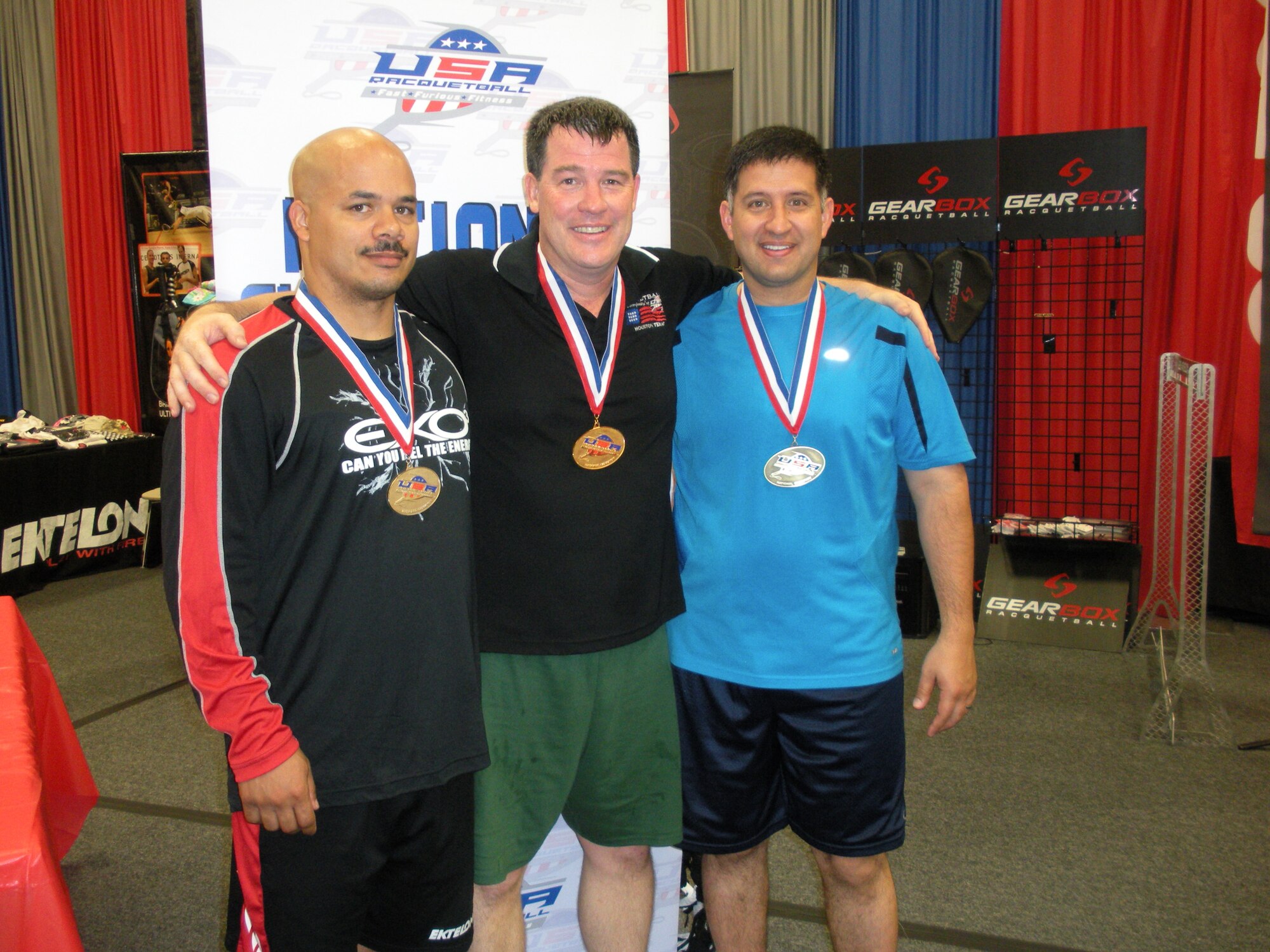 Lt. Col. Donald Jorgensen (center) celebrates after the medal presentation with fellow medalists Lt. Col. Kim Thein and Master Sgt. Michael Mack