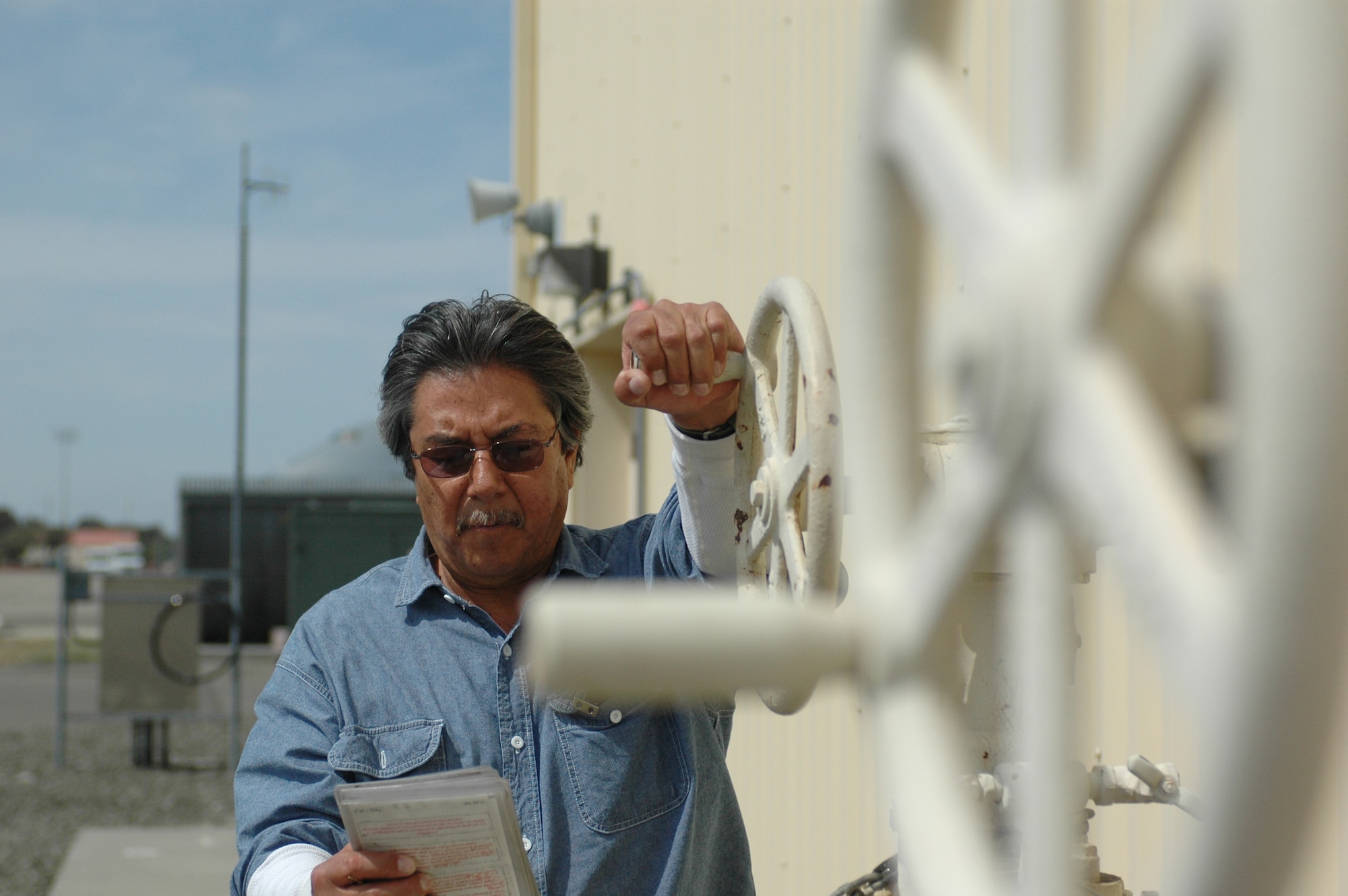 Vic Montoya demonstrates a fuel receipt at a hydrant station. Mr. Montoya is a member of the 60th Logistics Readiness Squadron's fuels management flight, which recently won the American Petroleum Institute's award for best in the Air Force. (U.S. Air Force photo/Nick DeCicco)