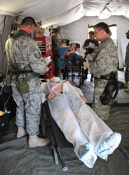 Medical group members treat victims during their certification for a Chemical Biological Radiological Nuclear High-Yield Explosives (CBRNE) Enhanced Response Force Package (CERF-P) in the immediate tent, a place for victims with significant emergency needs. Members of the 106th Medical Group and 106th Security Forces Squadron participate in Empire '09 Plus, a National Guard Support to Civil Authorities Exercise, on June 6, 2009 at the Office of Fire Prevention and Control's Urban Search and Rescue Center in Albany, N.Y. 

(U.S. Air Force Photo/Staff Sgt. David J. Murphy)
