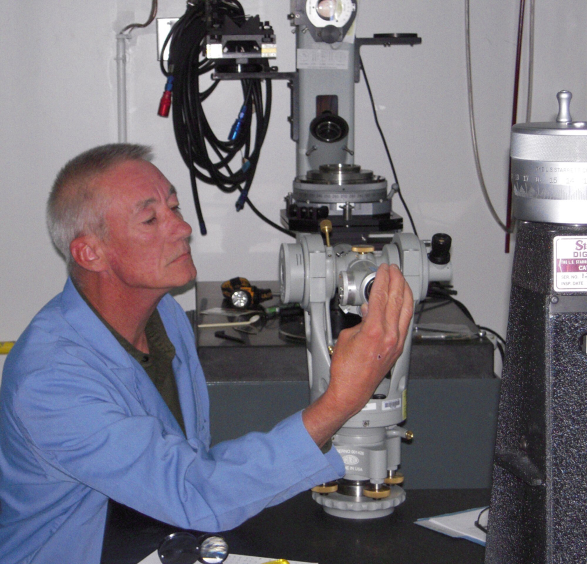 WHITEMAN AIR FORCE BASE, Mo. – Tony Garrison, Precision Measurement Equipment Laboratory technician, adjusts an Optical Transit Square. The piece of equipment is primarily used to align B-2 surfaces.  Mr. Garrison is using a Height Transfer Standard apparatus for the procedure, which takes about 10 hours if all goes well. (US Air Force Photo/SSgt Bryan Vandersommen)