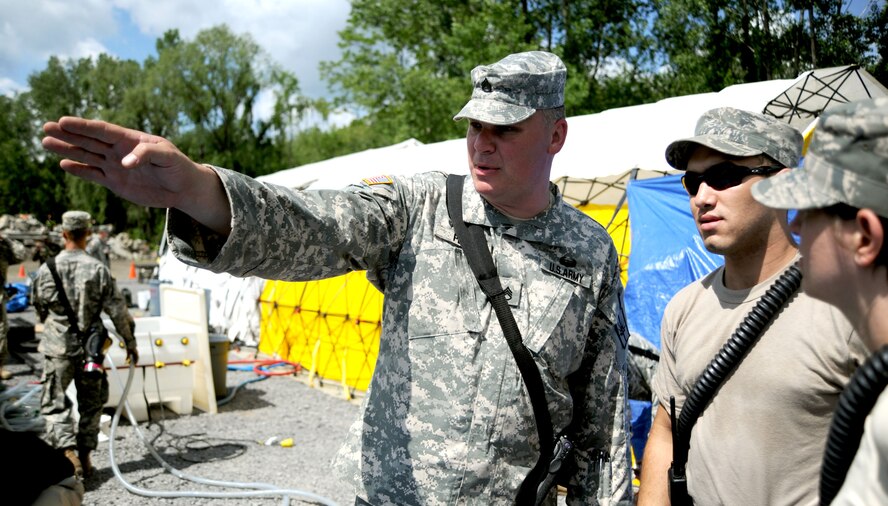 Staff Sgt. Ernest Penn, squad leader for the 105th Military Police Company speaks to members of the Air National Guard including Senior Airman Rocco Piccolo III of the 106th Medical Group.  Members of the 106th Medical Group and 106th Security Forces Squadron participate in Empire '09 Plus, a National Guard Support to Civil Authorities Exercise, on June 6, 2009 at the Office of Fire Prevention and Control's Urban Search and Rescue Center in Albany, N.Y. 

(U.S. Air Force Photo/Staff Sgt. David J. Murphy)