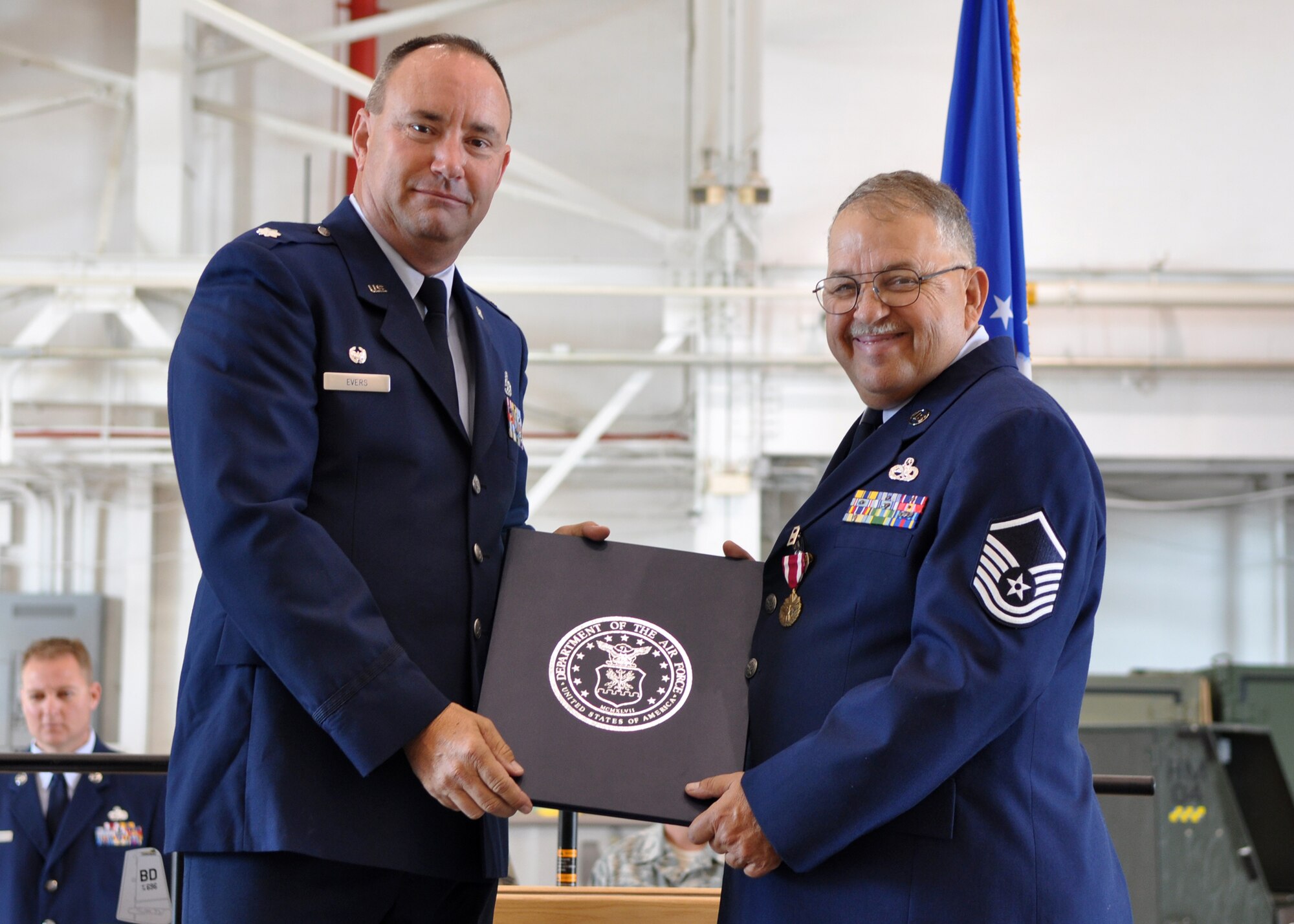 Master Sgt. (Ret) James Guggenheim receives his retirement certificate from Lt. Col. Chris Evers, 717th Aircraft Maintenance Squadron, commander, during one of the retirement ceremonies held in the A-10 Hangar at Barksdale Air Force Base, La., June 6, 2009. Master Sgt. Guggenheim is one of three Airmen from the 917th Wing who retired on the anniversary of the D-Day invasion of June 6, 1944. The retirements mean a loss of more than 101 years of total experience to the 917th Wing. Master Sgt. Guggenheim retired after 31.5 years of service. Also retiring were Master Sgt. Sterling “Pete” Bretzman with 37 years of service and Technical Sgt. Thomas Goerner with 33 years of service. (U.S. Air Force photo/Tech. Sgt. Jeff Walston) 