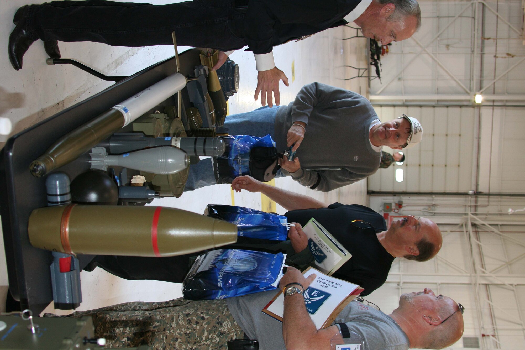 Mr. Paul Dayen, Chief of Emergency Management with the 911th Mission Support Group, talks to employers about various types of explosive ordinance during the June Unit Training Assembly. The ordinance display was one of the various ways in which employers were educated on 911th Airlift Wing mission as part of Employer's Day 2009. (photo by Staff Sgt. Roberto Modelo)
