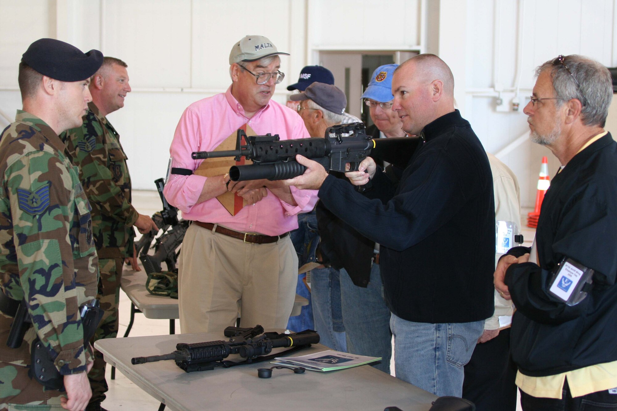 Tech. Sgt. Tom Merz, a combat arms instructor with the 911th Security Forces Squadron, instruct Mr. Ken Martin of Hebco Inc. how to handle an unloaded M-16/M-203 Grenade Launcher. The weapon, and others like it, were on display during the June Unit Training Assembly as part of Employer's Day 2009.