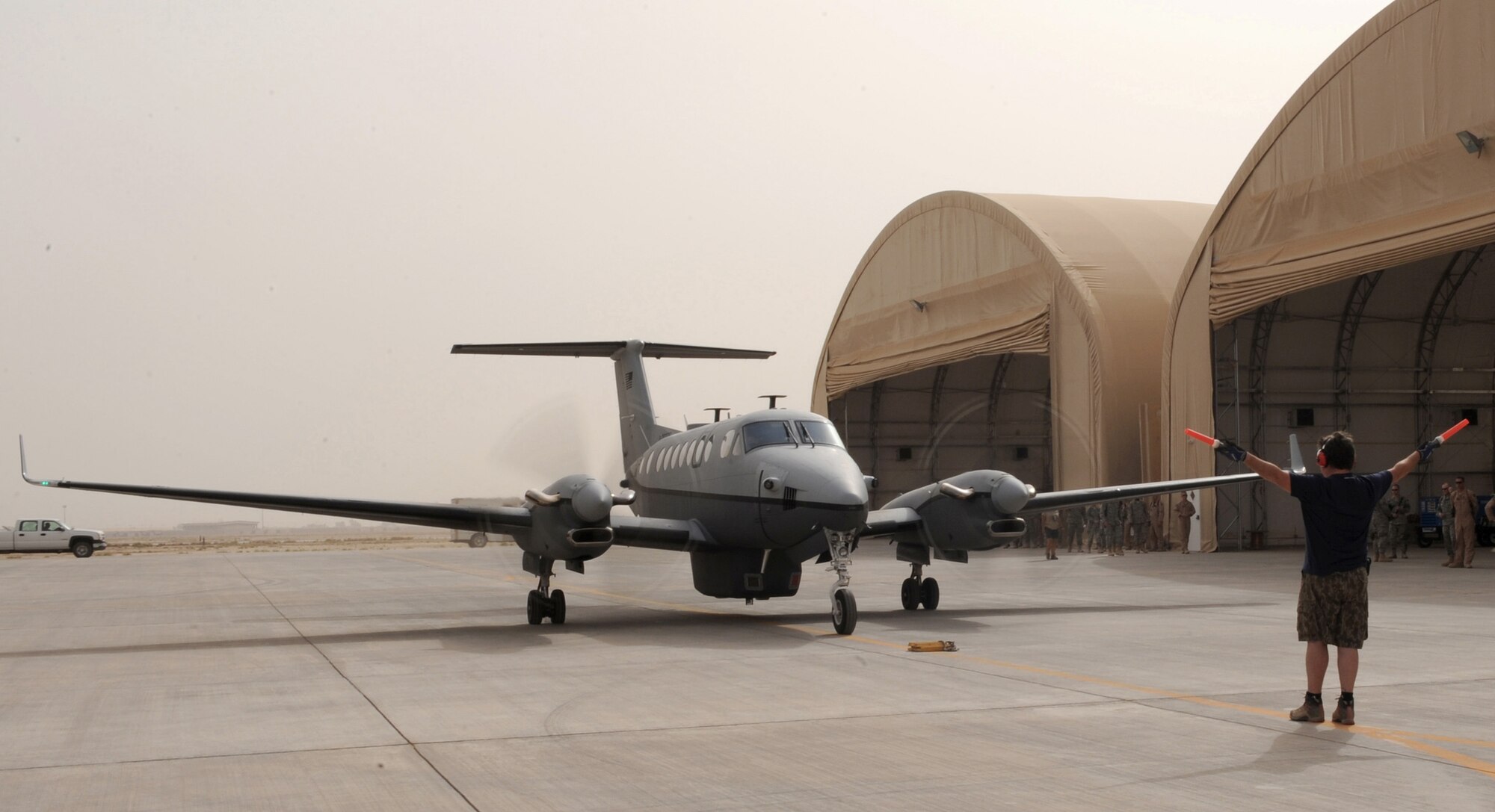 The Air Force's new MC-12 Liberty aircraft and the first one deployed in-theater taxies into an aircraft hangar June 8 at Joint Base Balad, Iraq. A medium-altitude manned special-mission turboprop aircraft designed for intelligence, surveillance and reconnaissance, MC-12 aircraft supports coalition and joint ground forces. (U.S. Air Force photo/Senior Airman Tiffany Trojca) 
