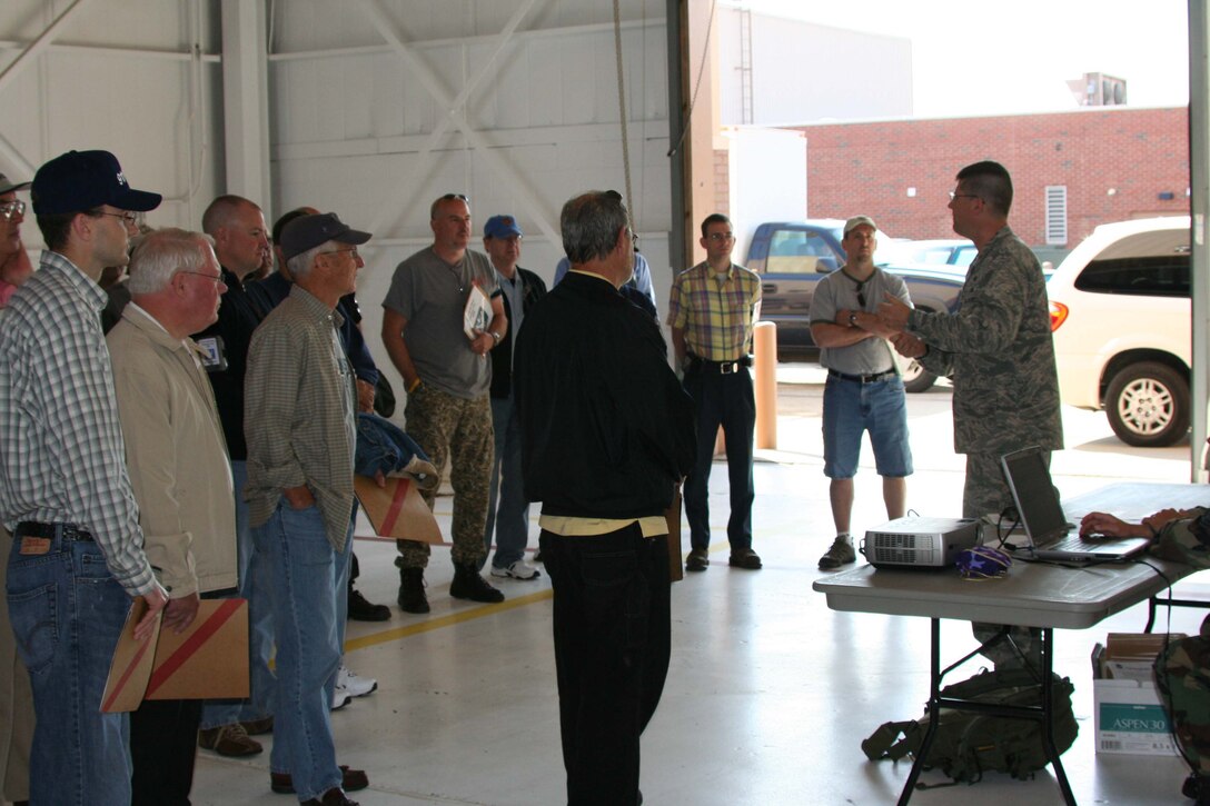 Maj. Charles Knapp, 911th Mission Support Flight Commander, briefs employers on what Airmen do when they process through a mobility line during mobilization. The employers were here during the June Unit Training Assembly as part of Employer's Day 2009. (photo by Staff Sgt. Roberto Modelo)

