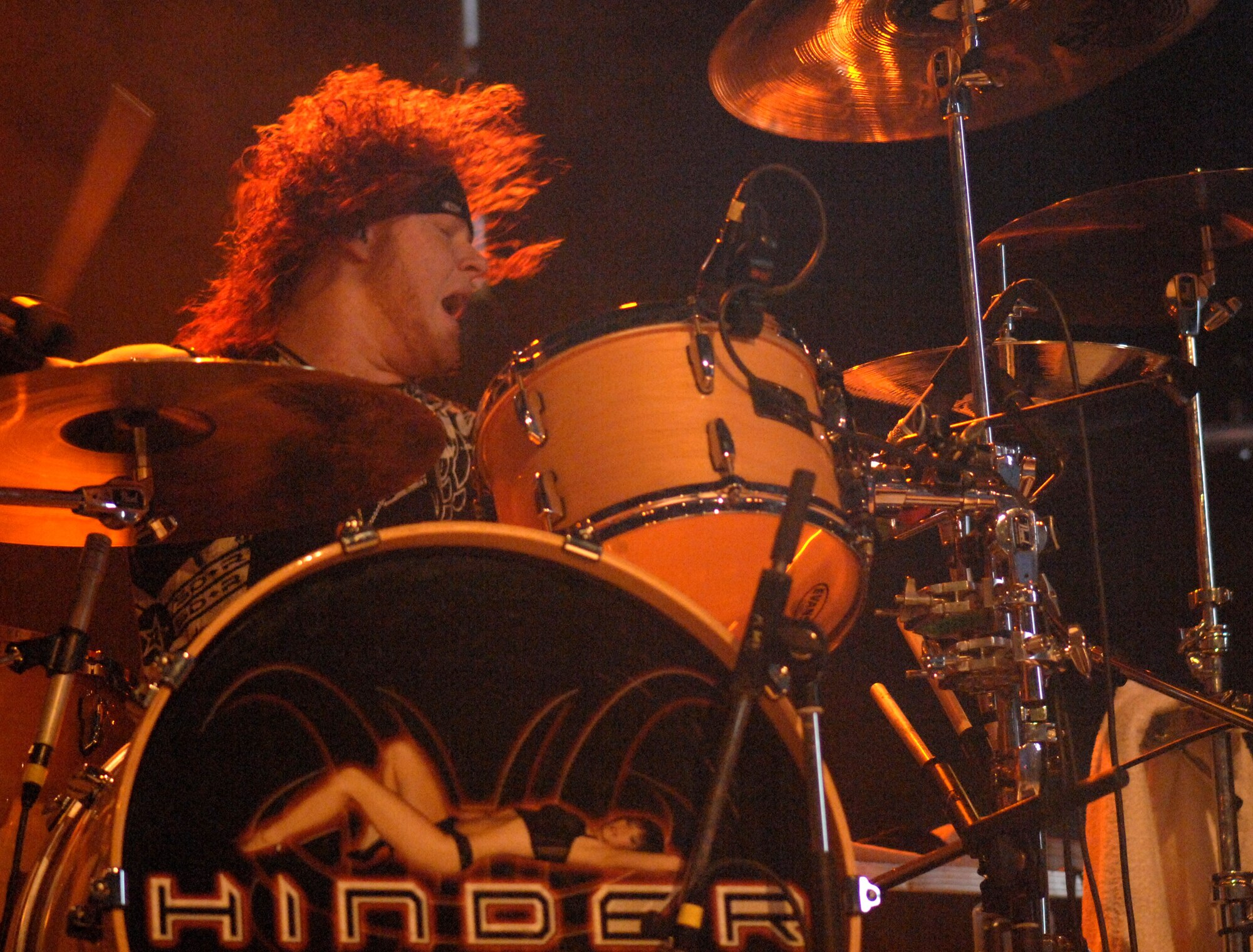 Cody Hanson, drummer for the rock band Hinder, aggressively plays to a packed audience at RAF Mildenhall, June 9.  Navy Entertainment and Armed Forces Entertainment sponsored the band for a six-base tour in Europe.  (U.S. Air Force photo by Staff Sgt. Christopher L. Ingersoll)