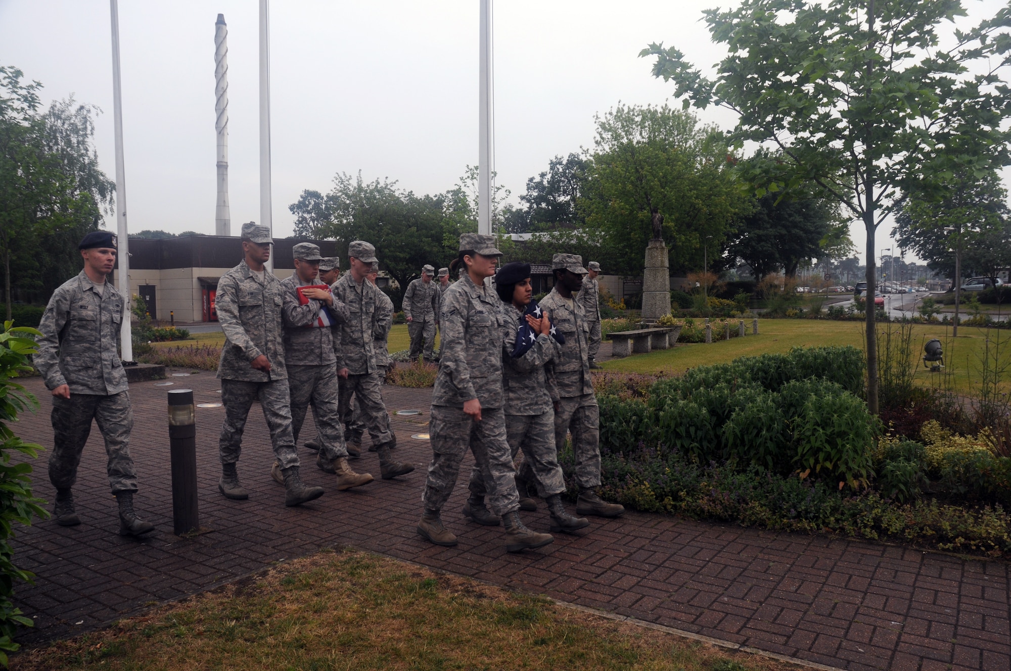 Airmen from the RAF Lakenheath First Term Airmen’s Center march in formation with the flags after a retreat ceremony signifying the end of the duty day June 10, 2009. During the ceremony, Airmen lower the American, Royal Air Force and Prisoner of War/Missing in Action flags while the British and American national anthems play. While both anthems are being played, Airmen and civilians across the base stop and render their respect to the flags. (U.S. Air Force photo by Senior Airman Kristopher Levasseur)
