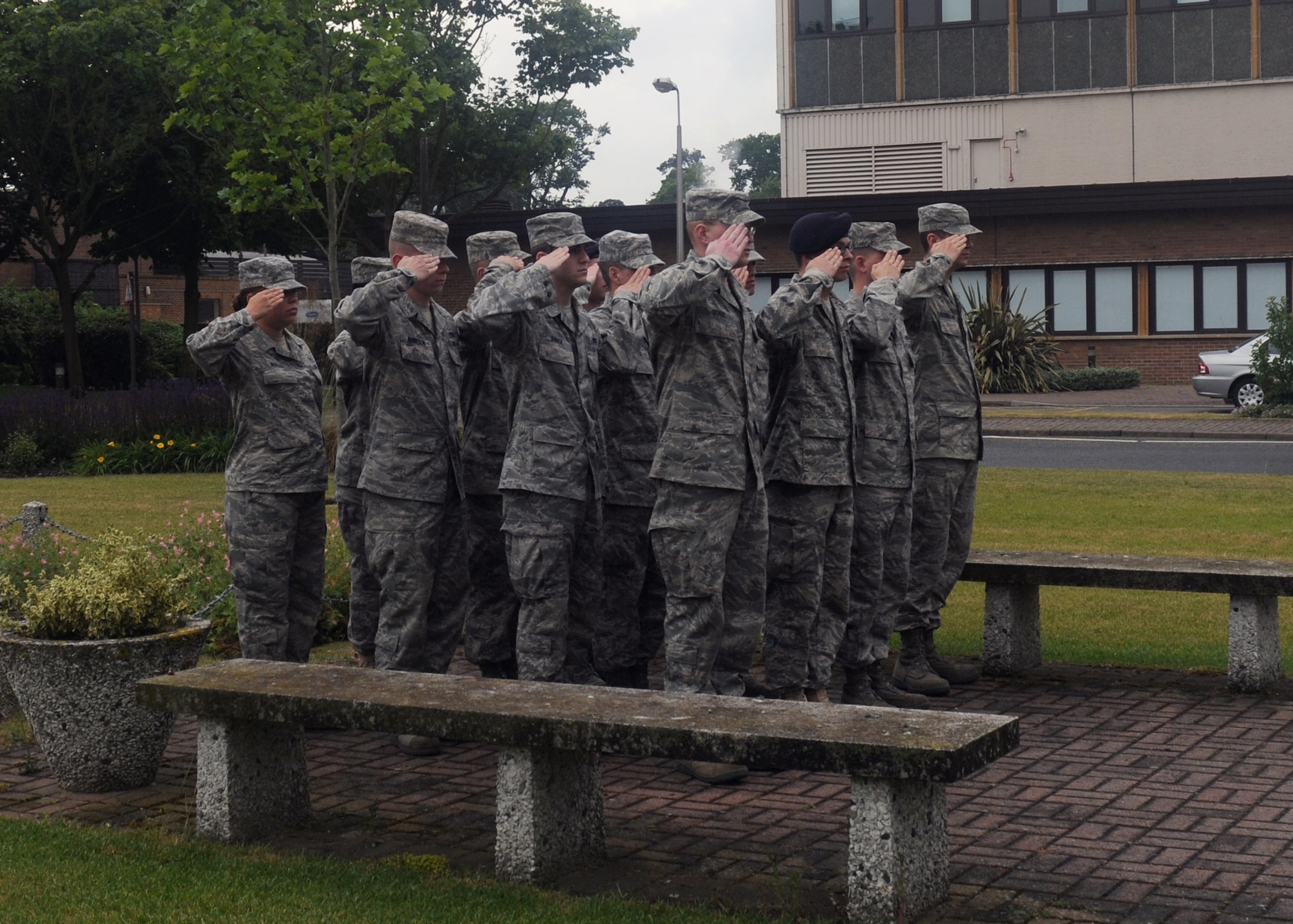 Airmen from the RAF Lakenheath First Term Airmen’s Center salute in formation as their fellow Airmen lower the flags during a retreat ceremony signifying the end of the duty day June 10, 2009. During the ceremony, the Airmen lower the American, Royal Air Force and Prisoner of War/Missing in Action flags while the British and American national anthems. While both anthems are played, Airmen and civilians across the base stop and render their respect to the flags. (U.S. Air Force photo by Senior Airman Kristopher Levasseur)