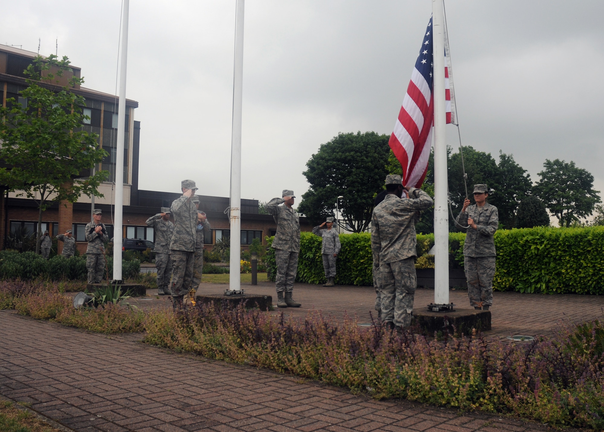 Airmen from the RAF Lakenheath First Term Airmen’s Center perform a retreat ceremony signifying the end of the duty day June 10, 2009. During the ceremony, the Airmen lower the American, Royal Air Force and Prisoner of War/Missing in Action flags while the British and American national anthems play. While both anthems are played, Airmen and civilians across the base stop and render their respect to the flags. (U.S. Air Force photo by Senior Airman Kristopher Levasseur)