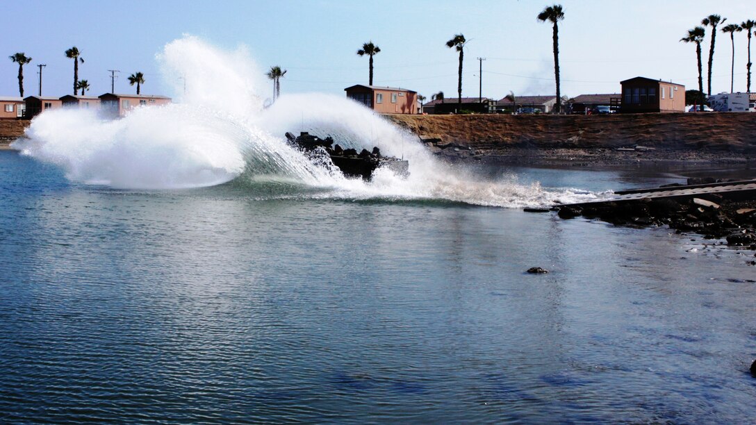 One of two Amphibious Assault Vehicles carrying Junior Marine Corps ROTC cadets from Jesuit High School New Orleans, La., hits the waters of the Del Mar Boat Basin on Camp Pendleton June 11.