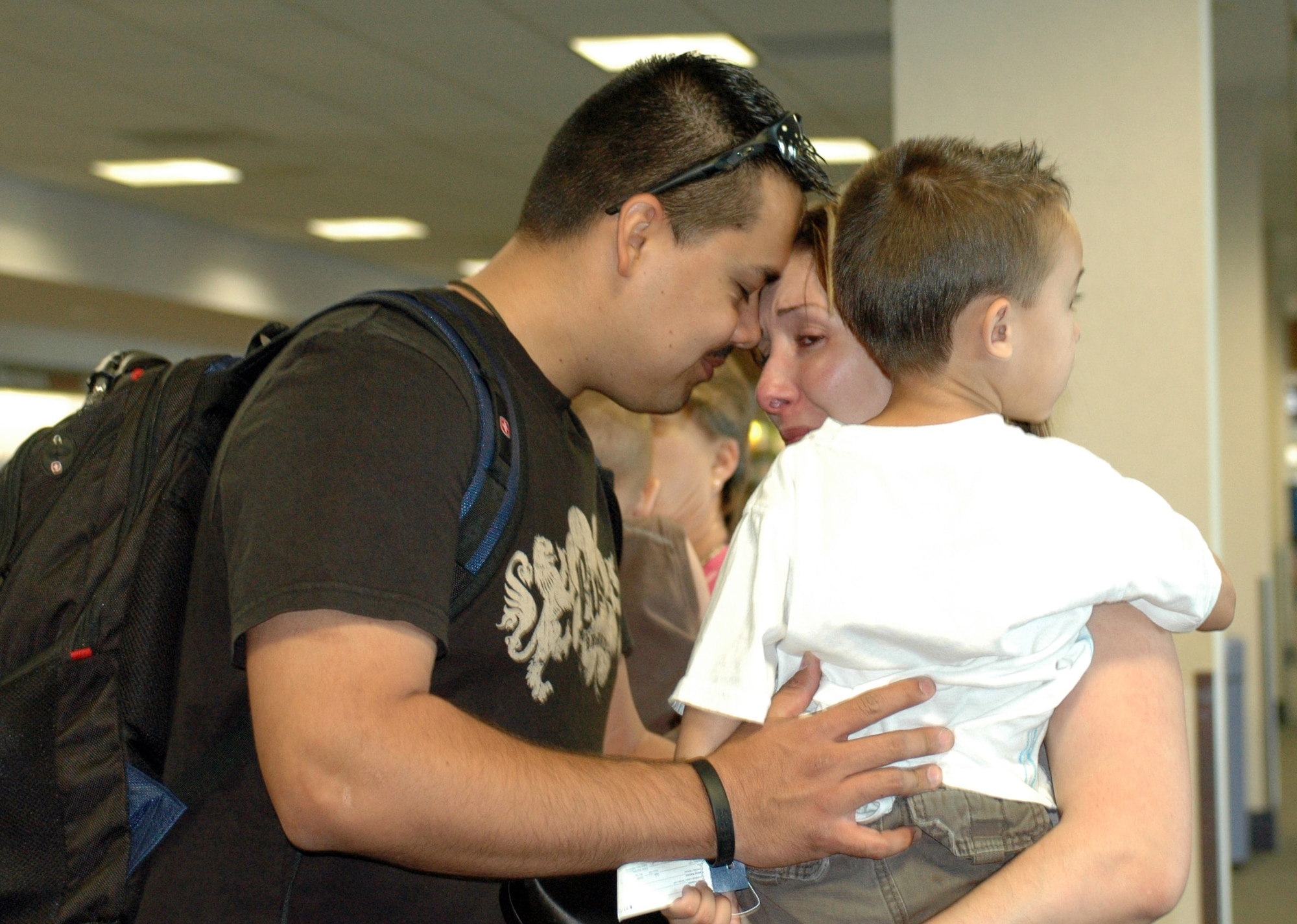 Staff Sgt. Santos Flores bids farewell to his wife Yvette and his son Andres at Tucson International Airport on his way to Al Dhafra Air Base in the United Arab Emirates, June 8. He left with nine fellow Guardsmen from the 162nd Fighter Wing’s force support squadron to provide food, fitness, lodging and recreation services to U.S. military members deployed to the area. The group is scheduled to return to Tucson in November. The deployment is Sergeant Flores’ first. (Air National Guard photo by Tech. Sgt. Desiree Twombly)