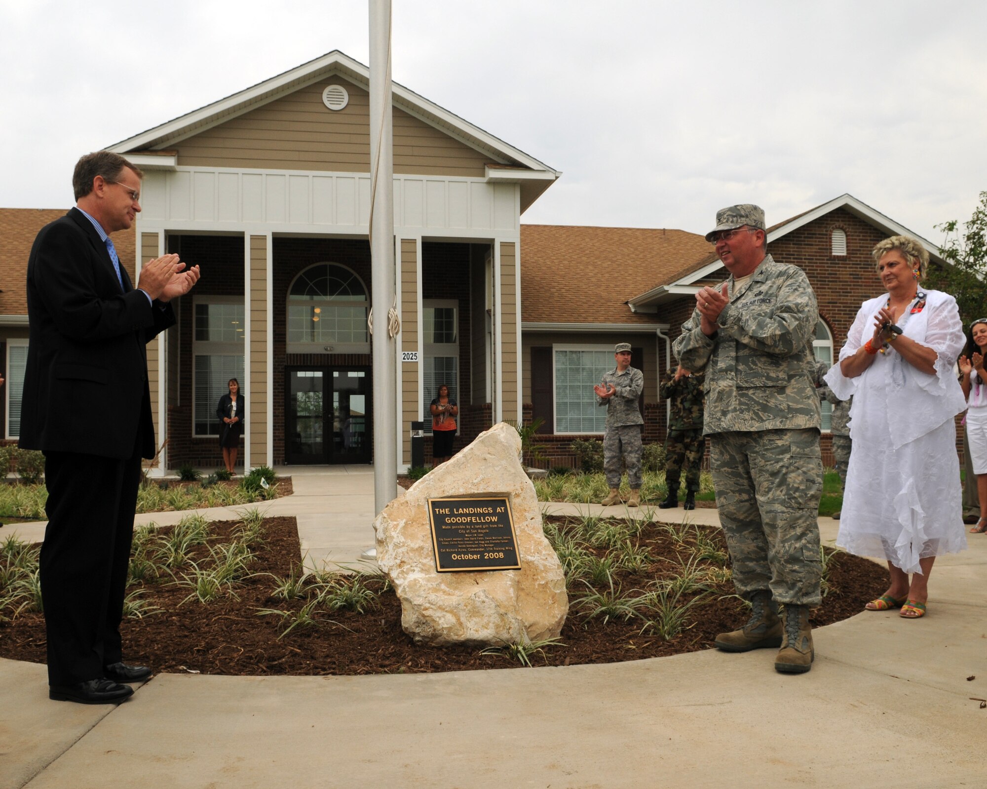 Dedicating a plaque thanking the City of San Angelo for their support and assistance with the gifting of 101 acres for building privatized housing at The Landings at Goodfellow are (from left to right) San Angelo Mayor pro tem Jon Mark Hogg, Col. Richard Ayres, 17th Training Wing commander, and Charlotte Farmer, San Angelo city councilwoman. (U.S. Air Force photo by Tech. Sgt. John Barton)
