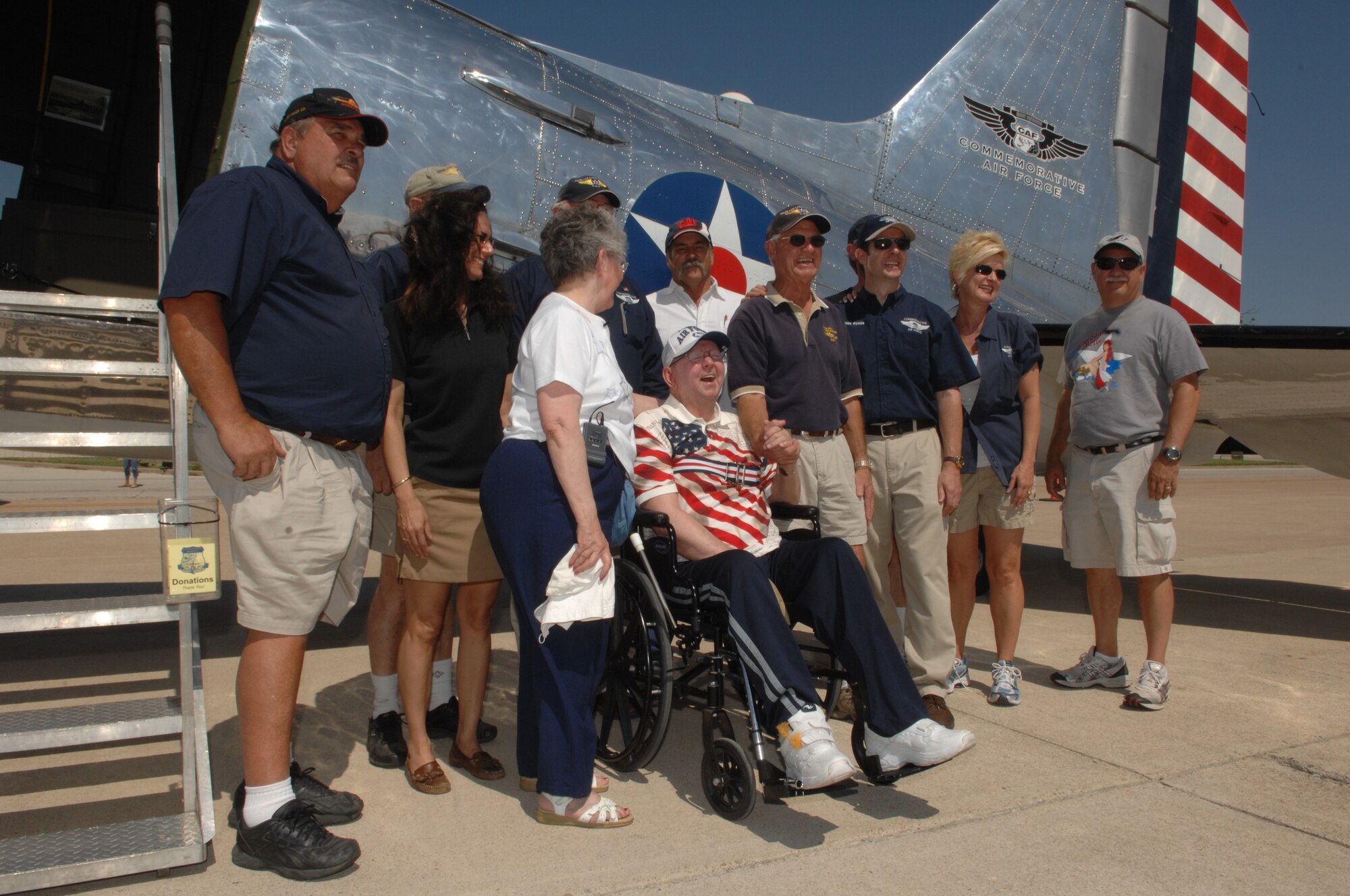 The team from the Commemorative Air Force pose with retired Master Sgt. Harry Siegrist and his wife outside the Bluebonnet Belle. (U.S. Air Force photo by Tech. Sgt. John Barton)