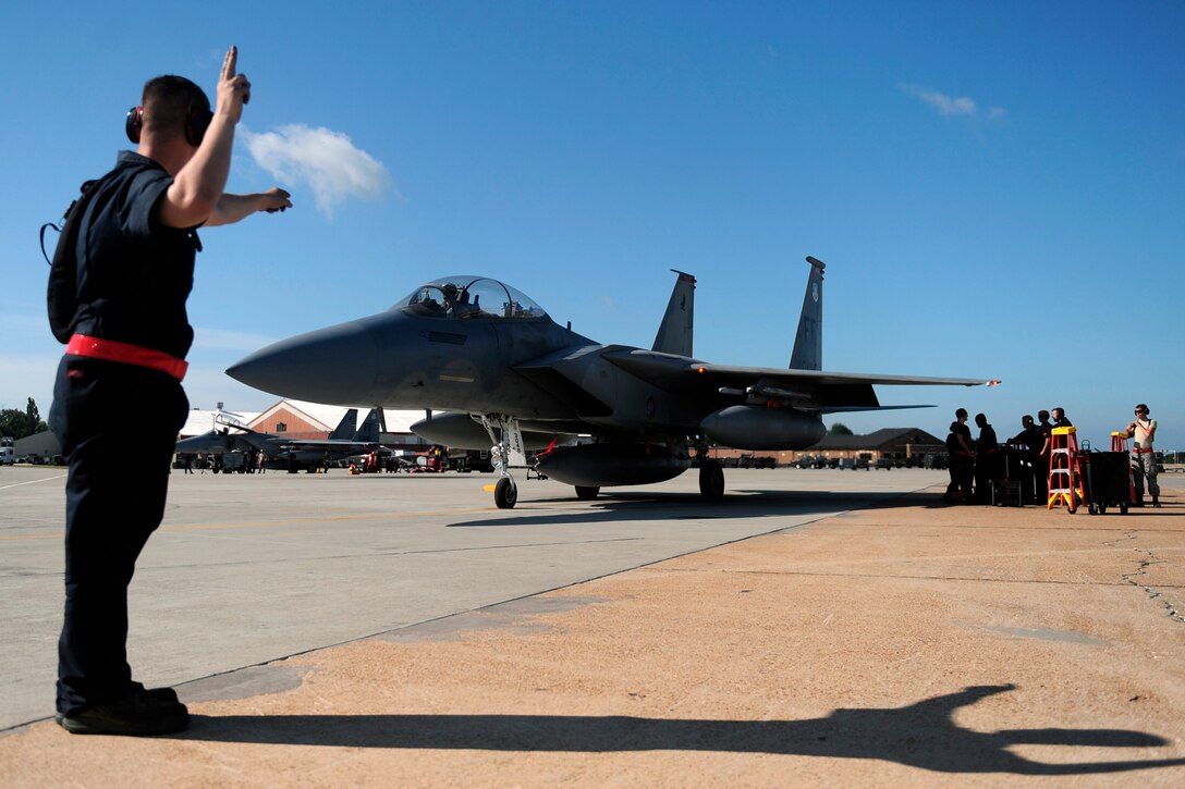 LANGLEY AIR FORCE BASE, Va. --  Senior Airman Max Ziegenhagen, 71st Fighter Squadron crew chief, marshals an F-15C onto the runway during a Phase I Operational Readiness Exercise here June 12. The Phase I ORE was conducted to test and prepare Langley Airmen for future deployments. (U.S. Air Force photo/Senior Airman Vernon Young)