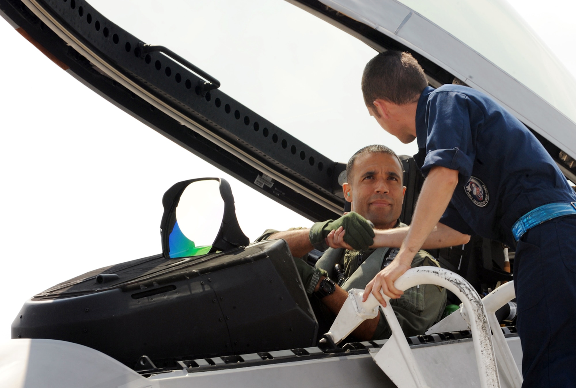 LANGLEY AIR FORCE BASE, Va.  -- Lt. Col. Adrian Spain, 94th Fighter Squadron commander, shakes hands with Airman 1st Class Brendan Carroll, 94th Aircraft Maintenance Unit crew chief, before doing dissimilar training in the F-22A Raptor at Kadena Air Base, Japan, June 6. More than 280 Airmen from the 94th Fighter Squadron, Virginia Air National Guard 192nd Fighter Wing, and 94th Aircraft Maintenance Unit deployed to Kadena as part of a Western Pacific theater security package May 26. (U.S. Air Force photo/Airman 1st Class Jarrod Chavana)
