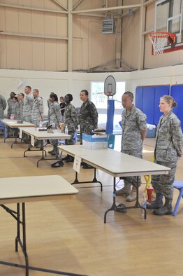 Volunteer Airmen man the "deployment line" for the Operation Junior R.A.P.T.O.R. program June 12 at Tyndall Air Force Base, Fla. Various units from across the base provided Airmen to help with the program, which helps orient children to the duties their military parents will perform when deployed. (U.S. Air Force photo/Staff Sgt. Joshua Stevens)