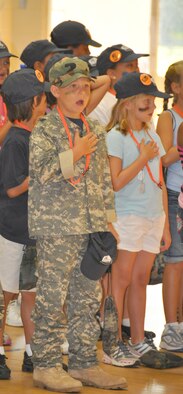 Nick Zeh, son of Col. David Zeh, 325th Mission Support Group commander, and others recite the Pledge of Allegiance June 12 at the Tyndall Youth Center as part of the Operation Junior R.A.P.T.O.R. program. Children who participated took part in a variety of activities, all targeted at orienting them toward the tasks their military parent(s) do while deployed. (U.S. Air Force photo/Staff Sgt. Joshua Stevens)