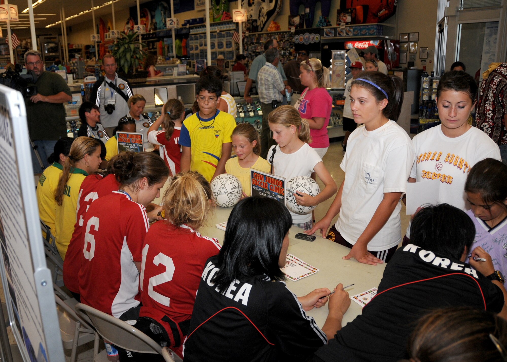 Members from teams attending the the 5th CISM Women’s Soccer Championship, hosted by Keesler Air Force base, sign autographs and participate in sport clinics June 12 at the soccer field on base and Academy Sports. Teams from Brazil, Canada, France, Germany, The Netherlands, The Republic of South Korea and The United States attended the clinics and autograph sessions and demonstrated some fundamentals of soccer.  (U.S. Air Force photo by Kemberly Groue)