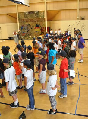 (Left center) Master Sgt. Michael Hair, 325th Force Support Squadron first sergeant, forms up his "troops" to prepare them for their "deployment" June 12 at Tyndall Air Force Base, Fla as part of the Operation Junior R.A.P.T.O.R. program. The purpose of the day was to give children an idea of what their military parents have to do when deploying abroad; the event was sponsored by the Airman and Family Readiness Center. (U.S. Air Force photo/Staff Sgt. Joshua Stevens)