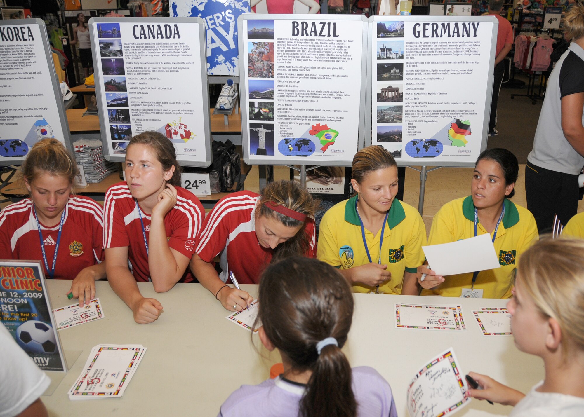 Members from teams attending the the 5th CISM Women’s Soccer Championship, hosted by Keesler Air Force base, sign autographs and participate in sport clinics June 12 at the soccer field on base and Academy Sports. Teams from Brazil, Canada, France, Germany, The Netherlands, The Republic of South Korea and The United States attended the clinics and autograph sessions and demonstrated some fundamentals of soccer.  (U.S. Air Force photo by Kemberly Groue)