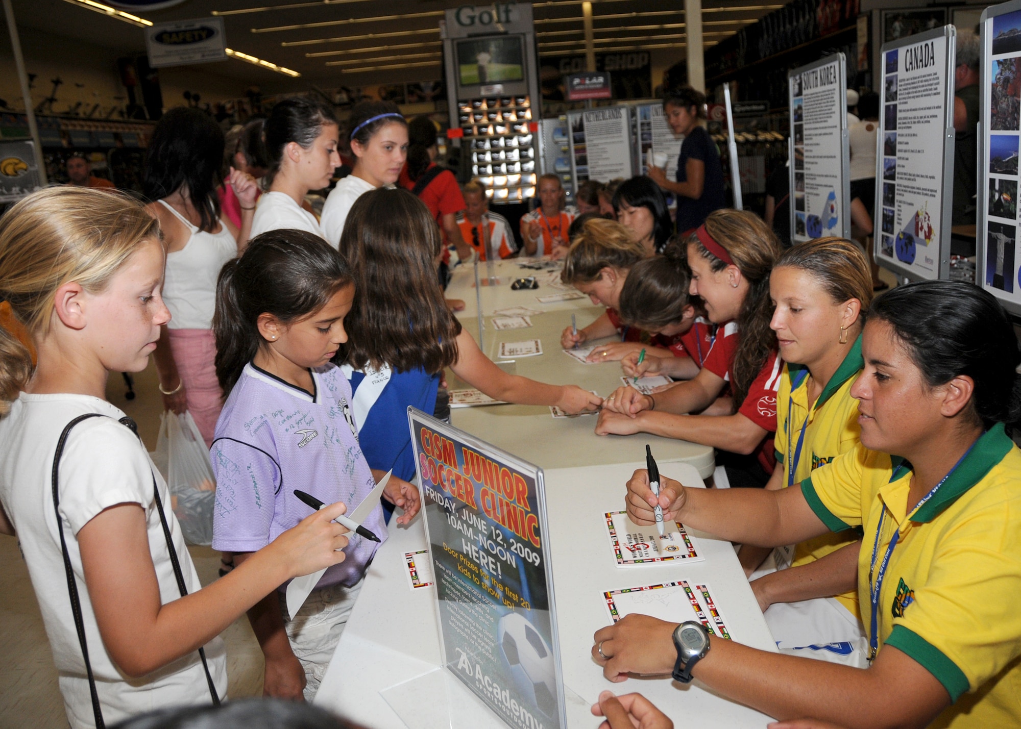 Members from teams attending the the 5th CISM Women’s Soccer Championship, hosted by Keesler Air Force base, sign autographs and participate in sport clinics June 12 at the soccer field on base and Academy Sports. Teams from Brazil, Canada, France, Germany, The Netherlands, The Republic of South Korea and The United States attended the clinics and autograph sessions and demonstrated some fundamentals of soccer.  (U.S. Air Force photo by Kemberly Groue)