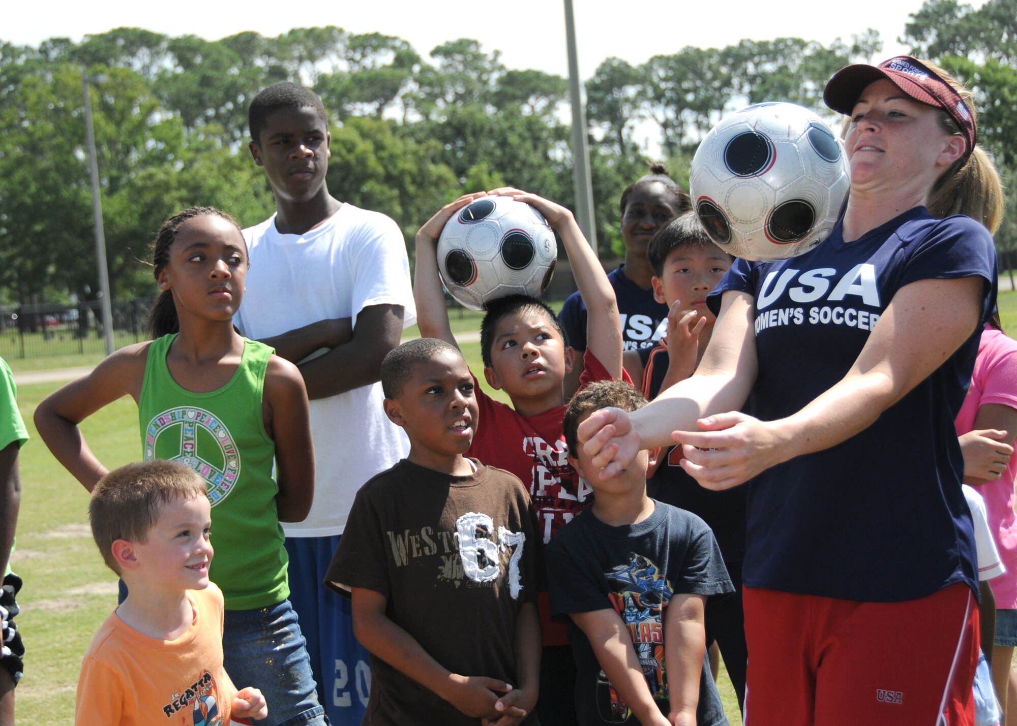 Members from teams attending the the 5th CISM Women’s Soccer Championship, hosted by Keesler Air Force base, sign autographs and participate in sport clinics June 12 at the soccer field on base and Academy Sports. Teams from Brazil, Canada, France, Germany, The Netherlands, The Republic of South Korea and The United States attended the clinics and autograph sessions and demonstrated some fundamentals of soccer.  (U.S. Air Force photo by Kemberly Groue)