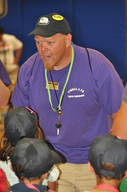 Johnny Sheeley, Tyndall Youth Center Youth Development Professional, motivates children participating in Operation Junior R.A.P.T.O.R. to give a "Hoo-Rah!" before they are "deployed" June 12 at Tyndall Air Force Base, Fla. The purpose of the day was to give children an idea of what their military parents have to do when deploying abroad. (U.S. Air Force photo/Staff Sgt. Joshua Stevens)