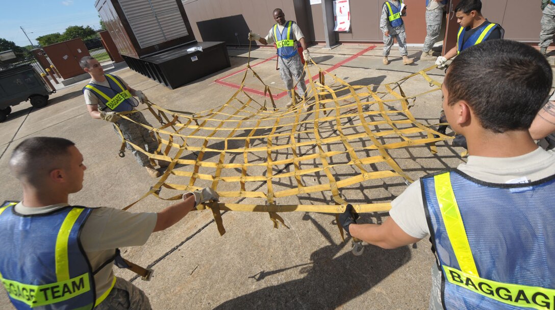 LANGLEY AIR FORCE BASE, Va. – Airmen of the 1st Medical Group prepare a cargo net for a pallet during an Operational Readiness Exercise here June 12.  The June 2009 Phase I ORE was conducted to test and prepare Langley Airmen for future deployments.  (U.S. Air Force photo/Staff Sgt. Barry Loo)