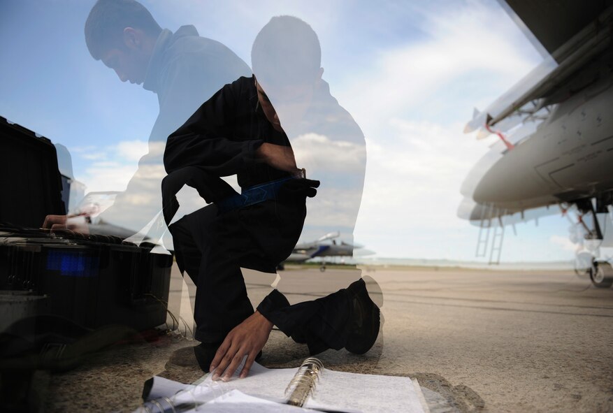 Airman 1st Class Derrick Mojica,  an F-15 Strike Eagle crew chief assigned to the 390th Aircraft Maintenance Squadron, Mountain Home Air Force Base, Idaho, prepares to troubleshoot his jet using his post-flight instruction manual during exercise Maple Flag 42 at 4 Wing Cold Lake, Canada, June 10. Maple Flag is a Canadian-sponsored and Air Combat Command supported exercise that provides aircrews simulated air and ground combat training to coalition forces in a NATO environment. (U.S. Air Force Photo/Senior Airman Larry E. Reid Jr.)
