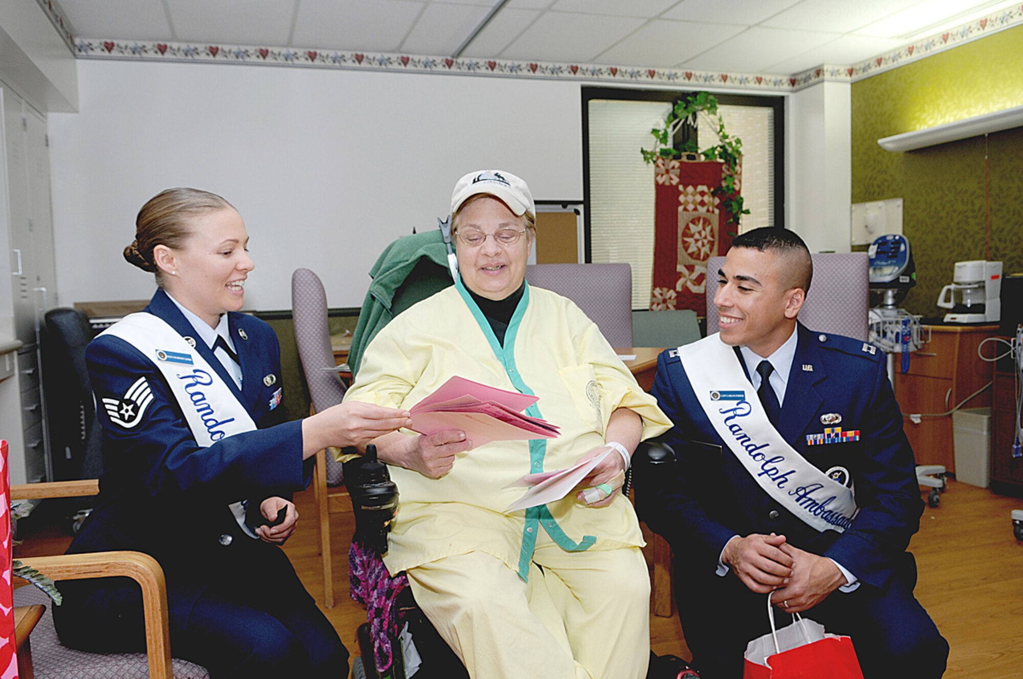 Staff Sgt. Courtney Linde, a 2009 Randolph Ambassador, presents valentines made by Randolph Elementary School students to a patient at the Audie L. Murphy Memorial Veterans Hospital as part of the Valentines for Veterans program. Sergeant Linde has battled bone cancer and overcome the death of her husband to excel as an Airman. (U.S. Air Force photo by Don Lindsey)