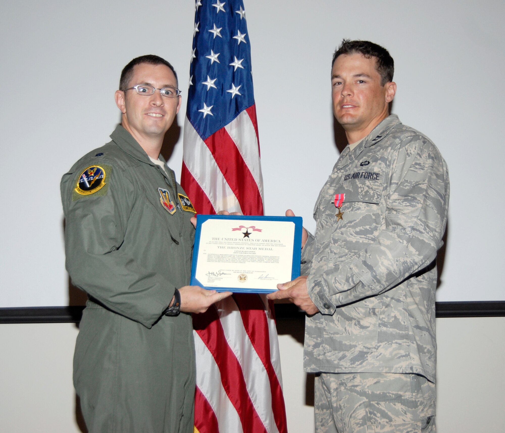 Lt. Col. Scott Guilbeault, 16th Electronic Warfare Squadron commander awards Capt. Blair Byrem with a Bronze Star Medal June 12 in the 53rd Weapons Evaluation Group auditorium. Captain Byrem earned his Bronze Star for his meritorious efforts during a six-month deployment to a Forward Operating Base near Bagram Airfield, Afghanistan in support of Operation Enduring Freedom. (U.S. Air Force photo/Robin Walters)
