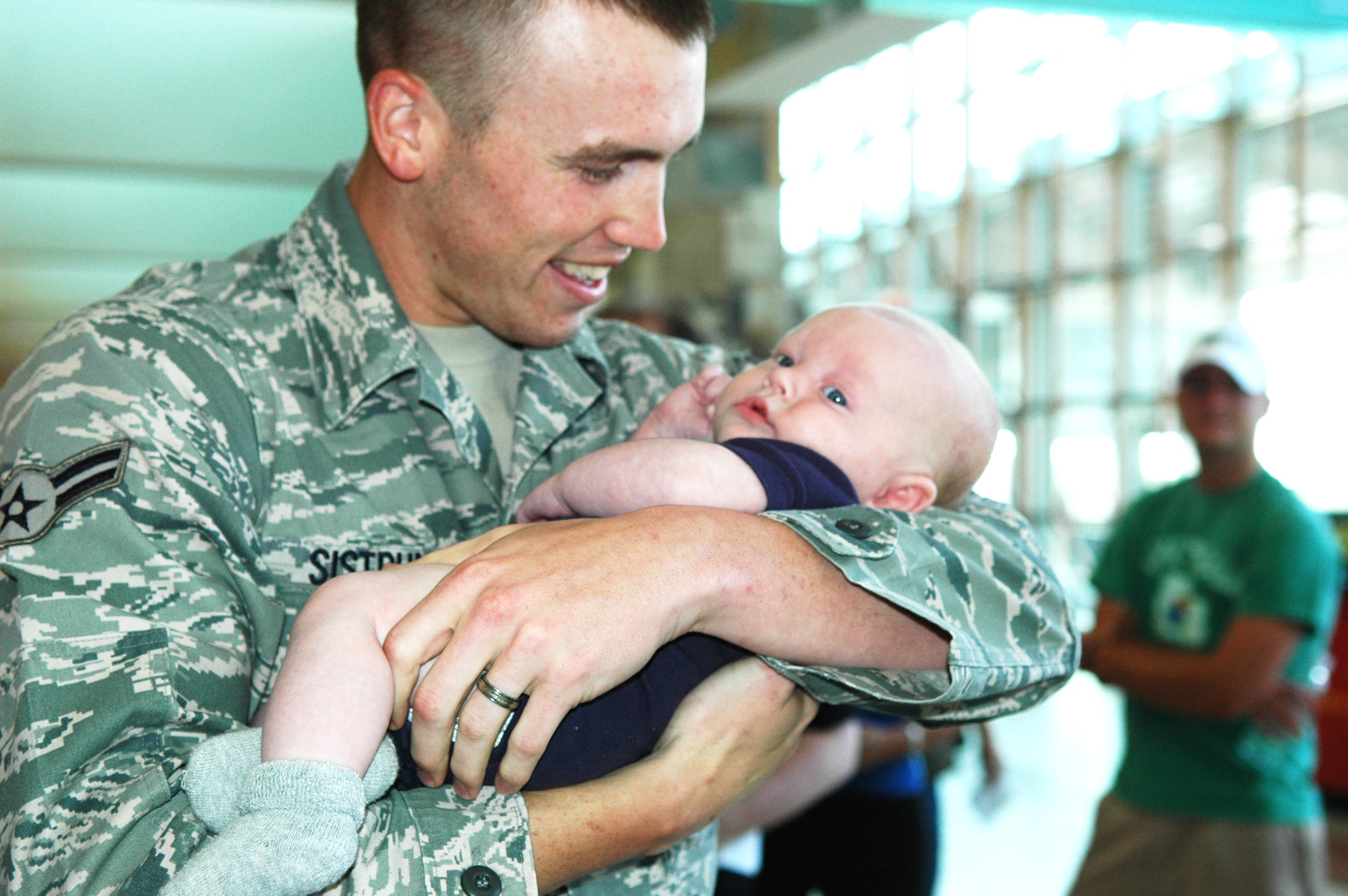 For 25 of Tinker’s Security Forces Airmen, Will Rogers World Airport in Oklahoma City became reunion central as they saw family and squadron mates for the first time in six months. The Airmen were deployed to Southwest Asia. The reunion was an emotional one for Airman 1st Class Brandon Sistrunk, 72nd Security Forces Squadron, who held his son, Landon Cade Sistrunk, for the first time. For Airman Sistrunk, who spent most of his time searching vehicles coming onto the base, the time was well spent. “It strengthened me,” he said. “It went pretty smooth, but the hardest thing was being away from family … and dealing with the heat.” Hundreds of Tinker Airmen are deployed daily in support of the  current fight. (Air Force photo by Brion Ockenfels)
