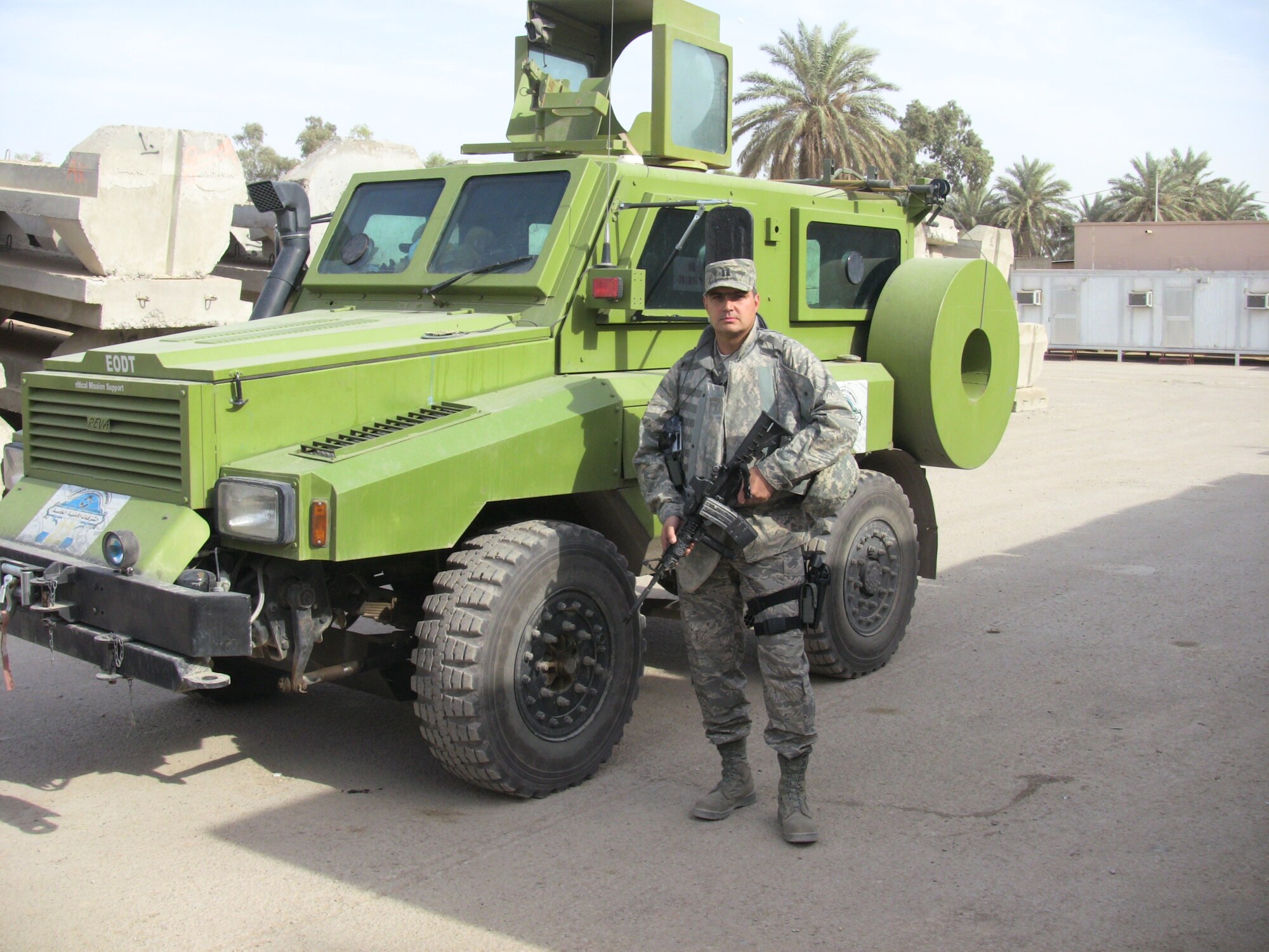 Capt. Jamey Hartsel, a contracting officer with the 727th Aircraft Sustainment Group, stands in front of an armored personnel carrier in Eastern Baghdad used by contractors in Iraq to transport personnel between forward operating bases. (Courtesy photo)