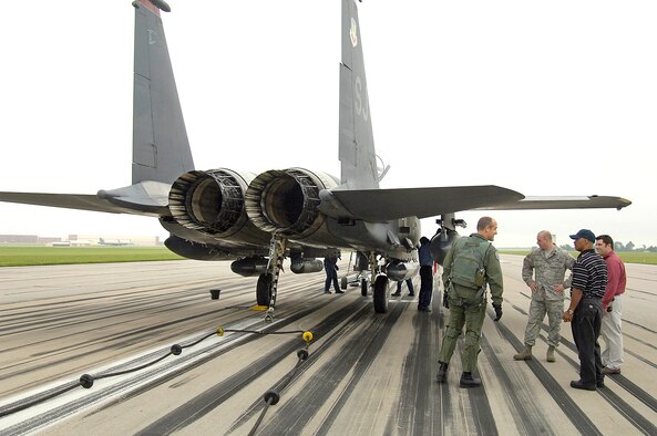 Tinker 72nd Operations Support Squadron and 72nd Civil Engineering Directorate personnel talk with an F-15 pilot from Seymour Johnson Air Force Base, N.C. after he tested the aircraft arresting cable. Air Force regulations require annual testing. The steel cable and tape system was successfully used in a real emergency last year. (Air Force photo/Margo Wright)