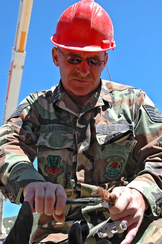 Tech. Sgt. Kenneth Leitch with the 201st REDHORSE Squadron finely tunes some equipment to be used on infrastructure repairs along the U.S.-Mexico border near Campo, Calif.  (Photo by Capt. Jay Ostrich)