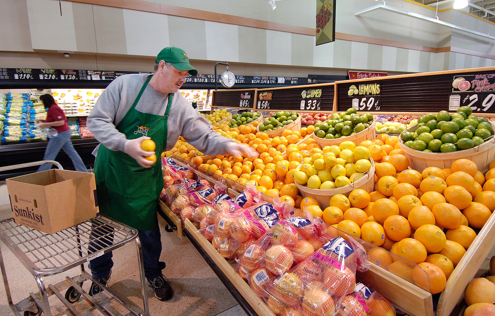 Chuck Routh stocks the produce department early in the day before the commissary fills with customers. The section is a large area that staffers work to keep ready for shoppers. (Air Force photo/Margo Wright)